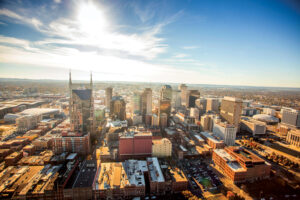 Nashville's city skyline sits below a blue, sunny sky