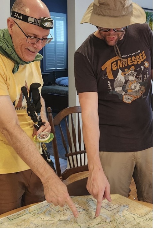 Chuck Sanders and Michael Goodman pointing at a map