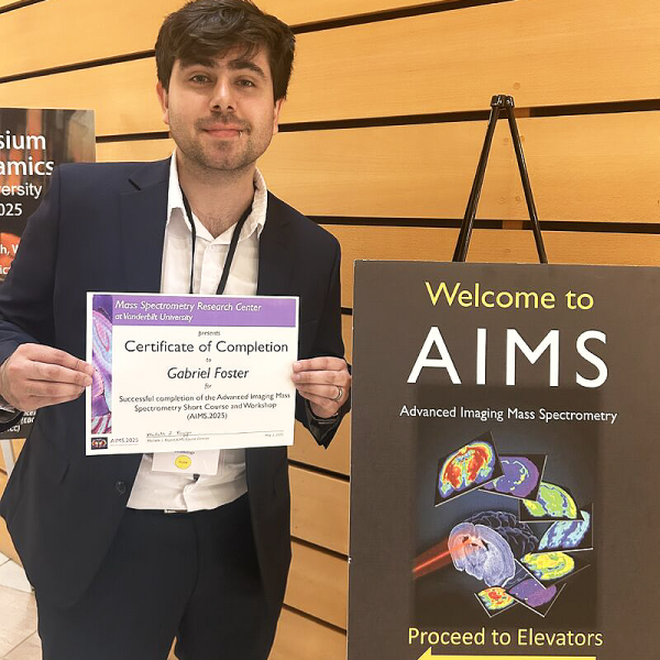 Photo of Gabriel Foster holding his AIMS 2025 certificate of completion.