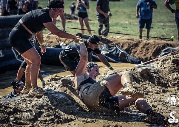 Hannah Waterman participating in a mud challenge