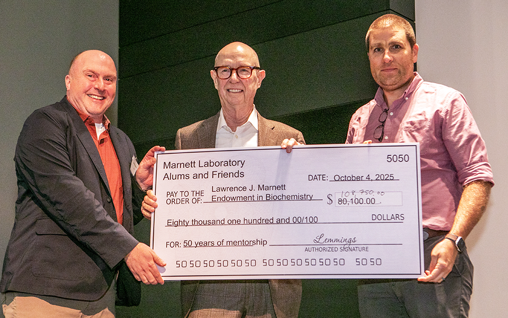 Lemming reunion organizers James West and Will Beavers present Larry Marnett with an endowment check.