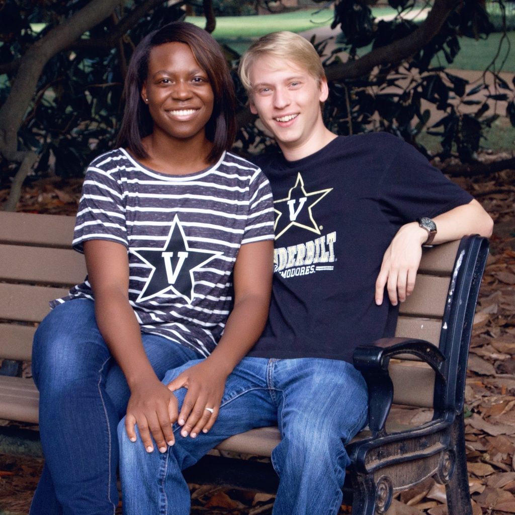 Kristin Kwakwa, left, and Kalen Petersen sitting on a bench outdoors. Both are wearing Vanderbilt t-shirts.