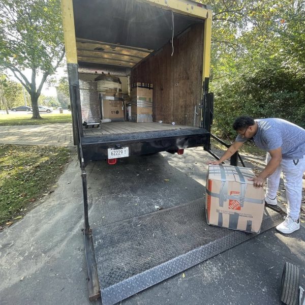 A man packs boxes into a truck