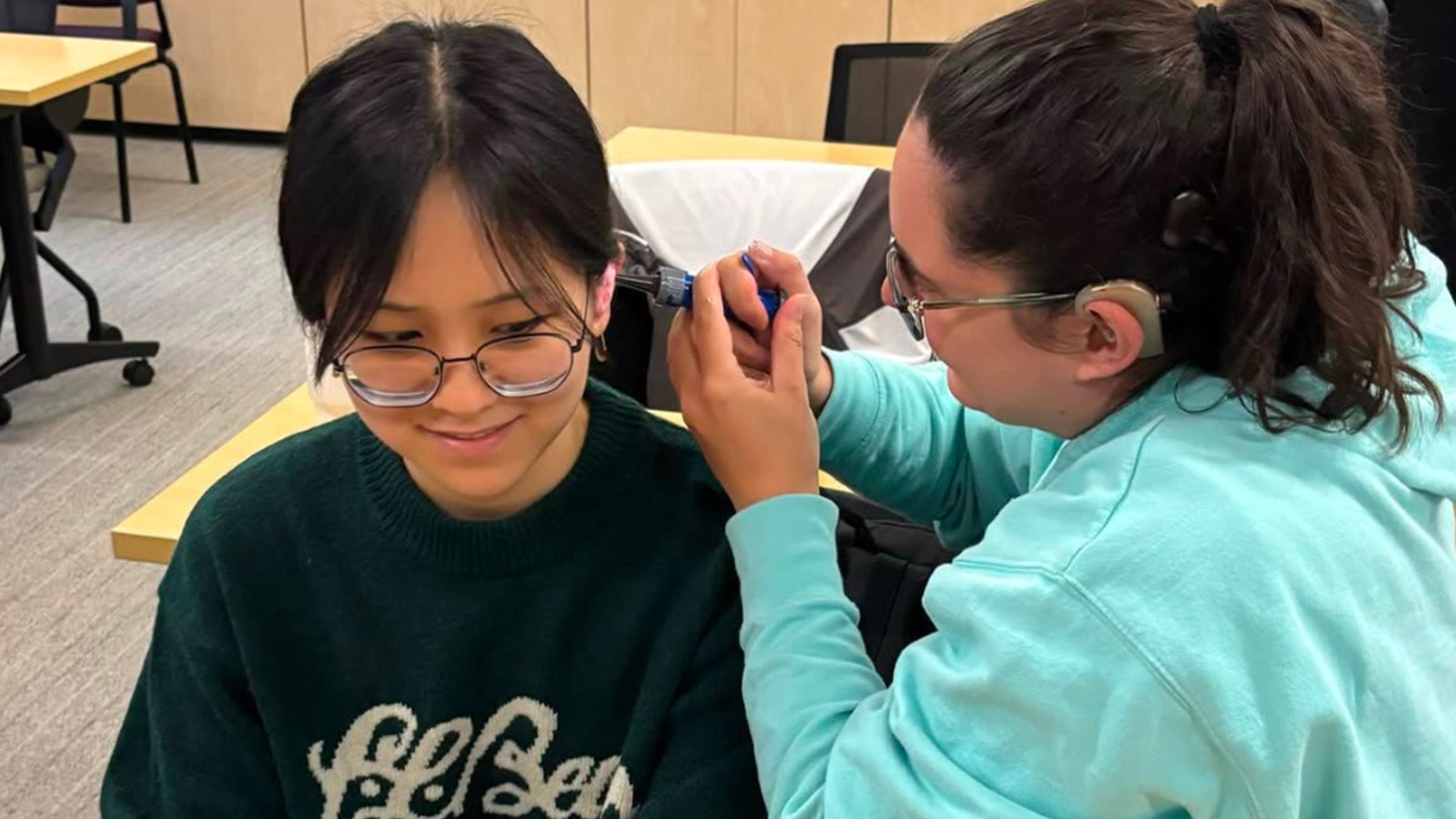 An audiology student practices making silicone ear molds on another student at Vanderbilt School of Medicine.