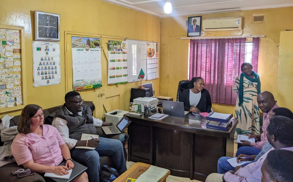 Frenia and THF team members speak with Ministry of Agriculture officers in Monze, Zambia.