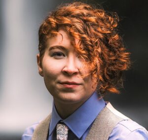 A scientist smiles for a professional headshot