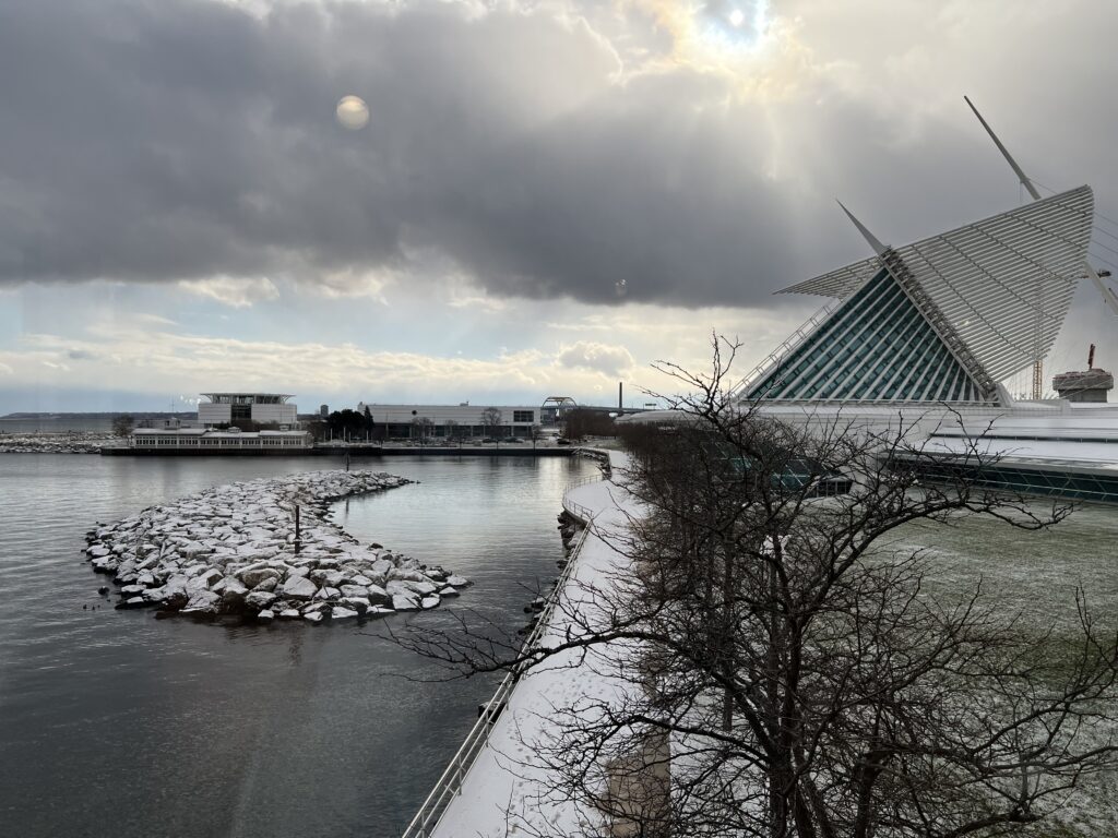 An art museum rises above cold water on a cloudy day