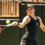 A Vanderbilt women's tennis player hits the ball