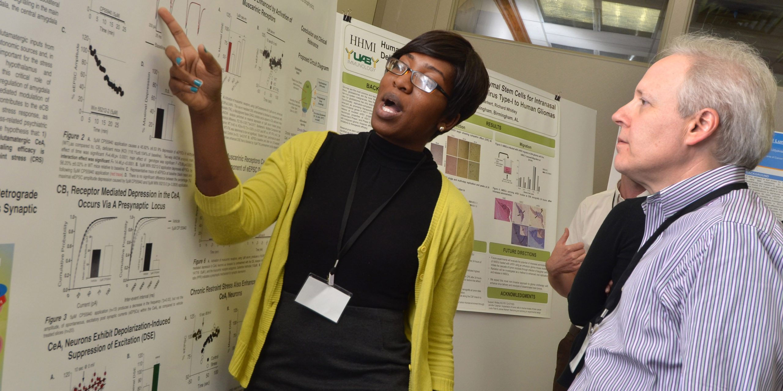 A trainee shares her poster with an APMM Mentor.