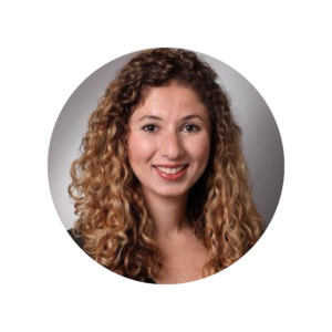 A woman with long curly hair smiles