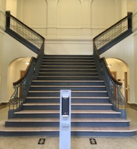 Mayborn's grand staircase, with hand sanitizer station.