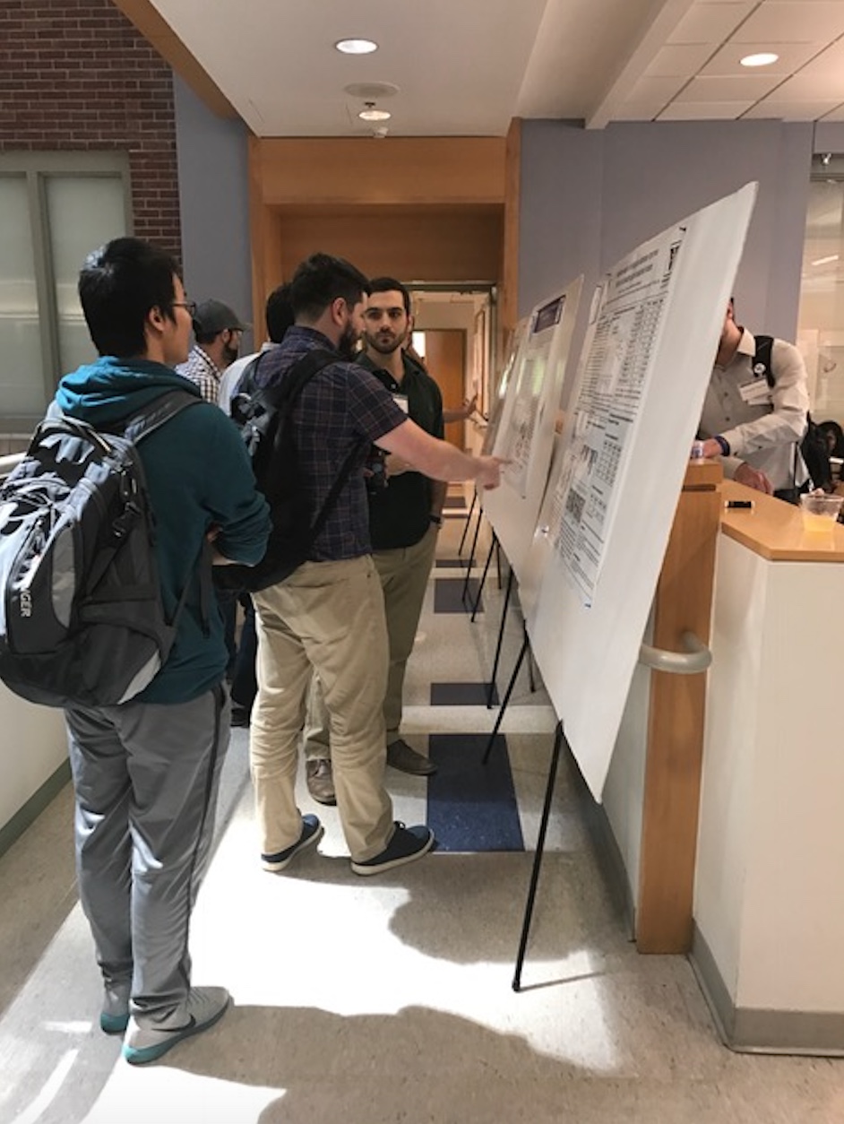 Alex Sevy presents an update on his research to symposium attendees