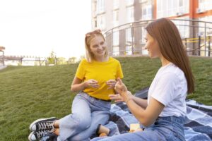female-friends-outdoors-using-sign-language