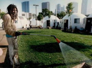 A resident maintains Dome Village's common yard.