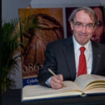 Bartels signing a large book