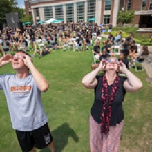 group of students observing solar eclipse