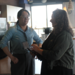 two women chat in the Centennial Perk lounge during the new student social for Vanderbilt Biostatistics 08.16.2024