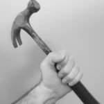 Hand holding hammer