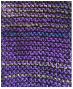 purple knitting with lines of grey and blue