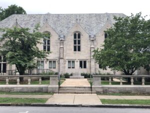 stone building flanked by trees