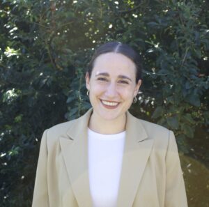 Person in tan blazer smiling