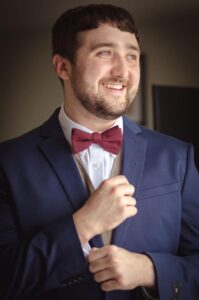 Person wearing suit and tie smiling