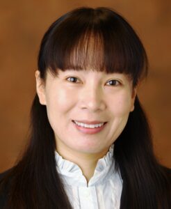 Person smiling in white blouse with black blazer