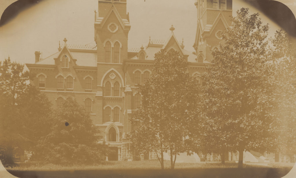 View of the front of Kirkland Hall in the 1890s showing small magnolias