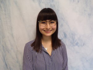 Headshot of Nicole Gillis with white and blue marble background