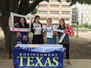 Four young women tabling outside with signs and flyers
