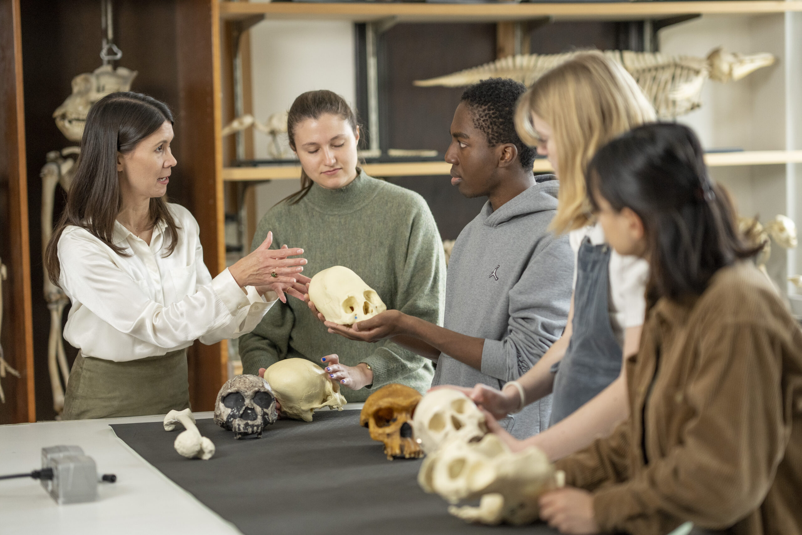 Dr. Tiffiny Tung discusses forensic analysis of skeletons in genocide cases with her Immersion class (Forensics, Genocide, and Human Rights) in the Osteology Lab.