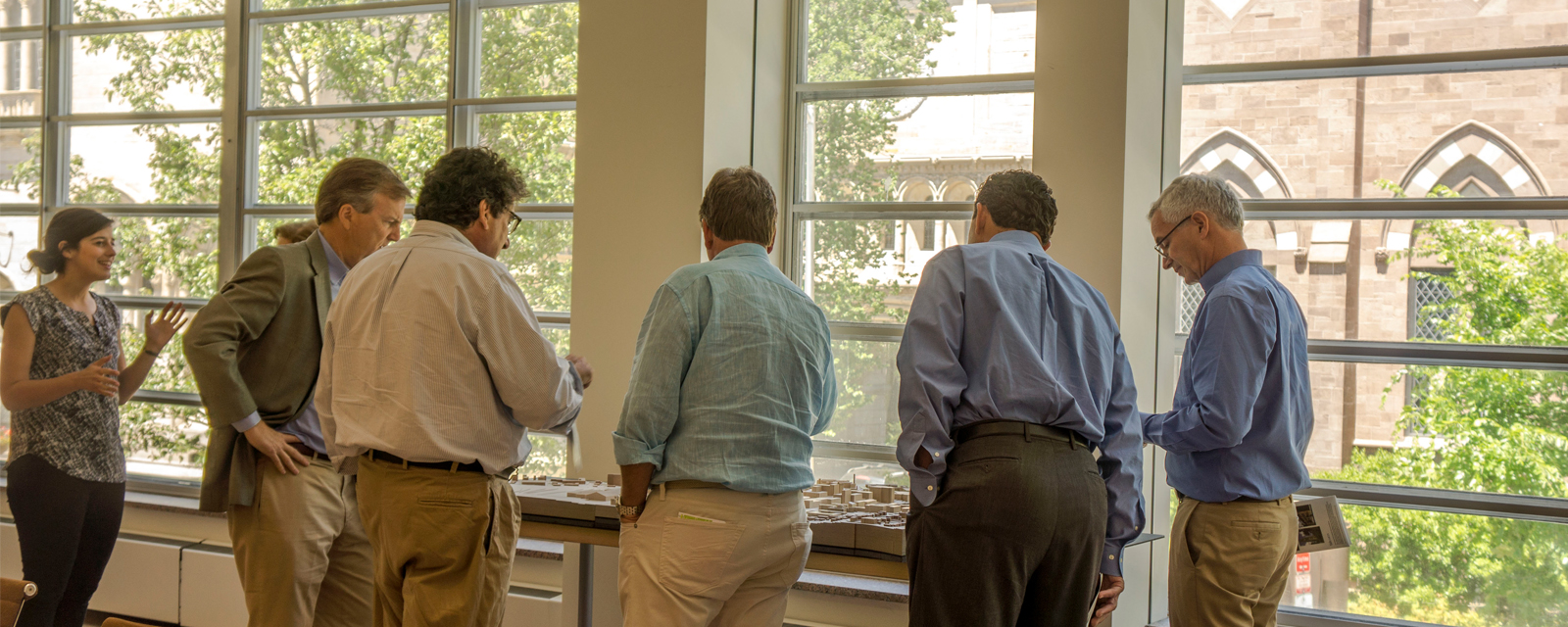 Trustees speaking with the Chancellor and reviewing building models