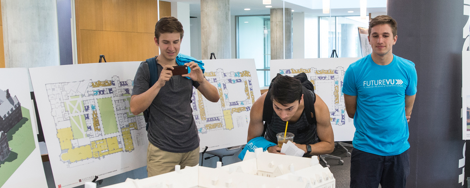 Photo of students looking at a building model at a FutureVU event