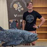 Reese stands with a coelacanth cast