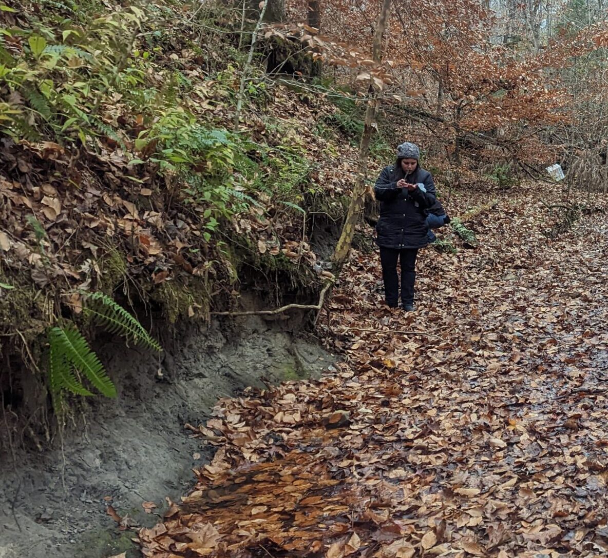 Monica Keith walking up the creek during a Coon Creek Science Center outreach day