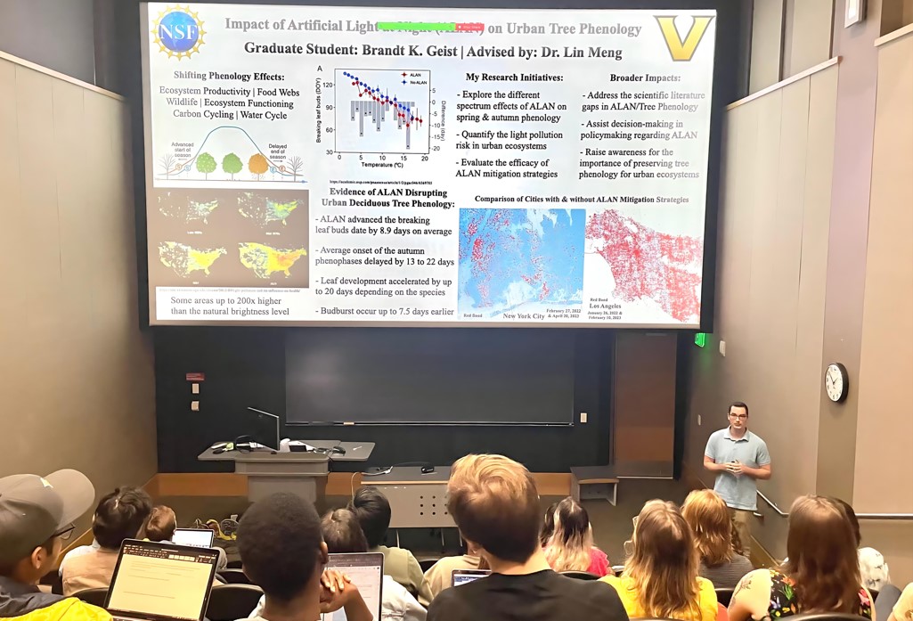 A graduate student, Brandt K. Geist, presenting research on the impact of artificial light on urban tree phenology in a lecture hall. The presentation slide shows data on shifting phenology effects, including delayed leaf development and changes in autumn phenophases, with satellite imagery comparing cities with and without artificial light at night (ALAN) mitigation strategies.