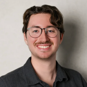 Josh wearing glasses and smiling