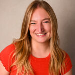 Ashlynn in a red shirt, smiling