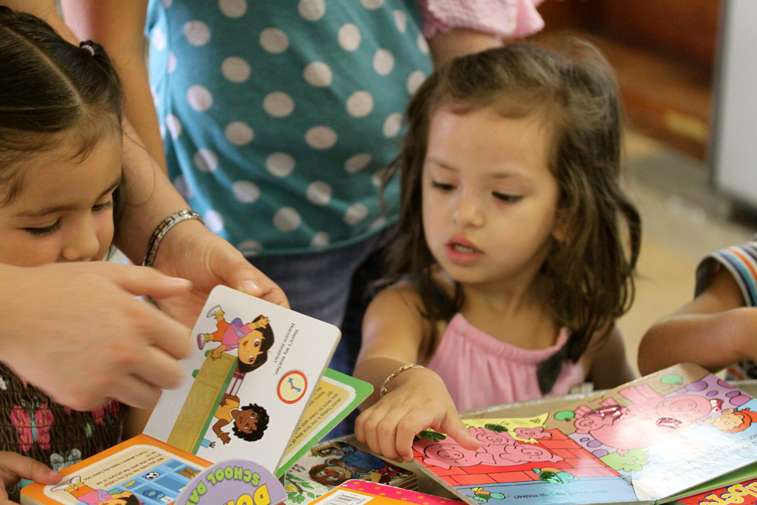 Two young chidren looking at board books