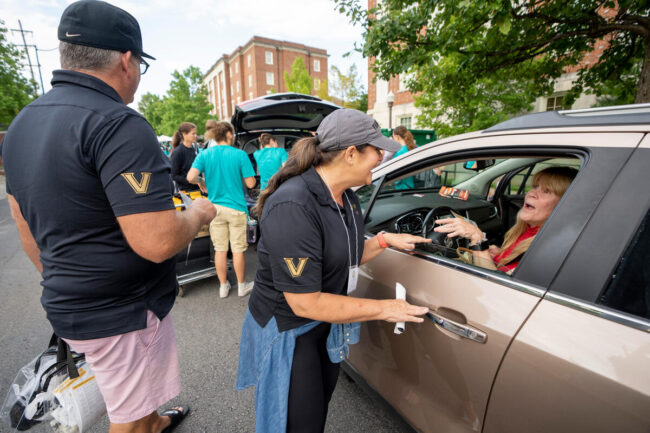 parents giving directions to woman in car