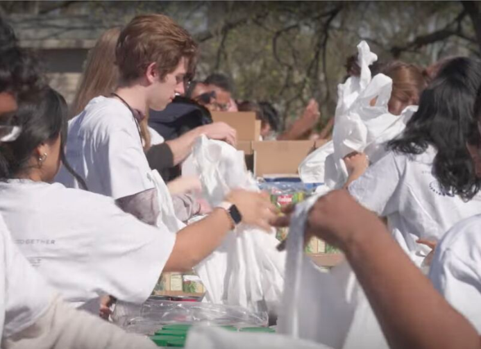 Vanderbilt student assembling food bags for distribution at a food drive event