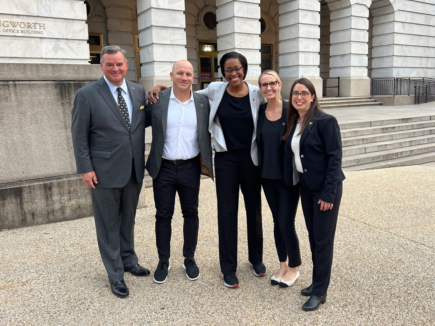 Nathan Green, Coach Lea, Candice Lee, Coach Ralph, and Christina West standing outside the U.S. Capitol building