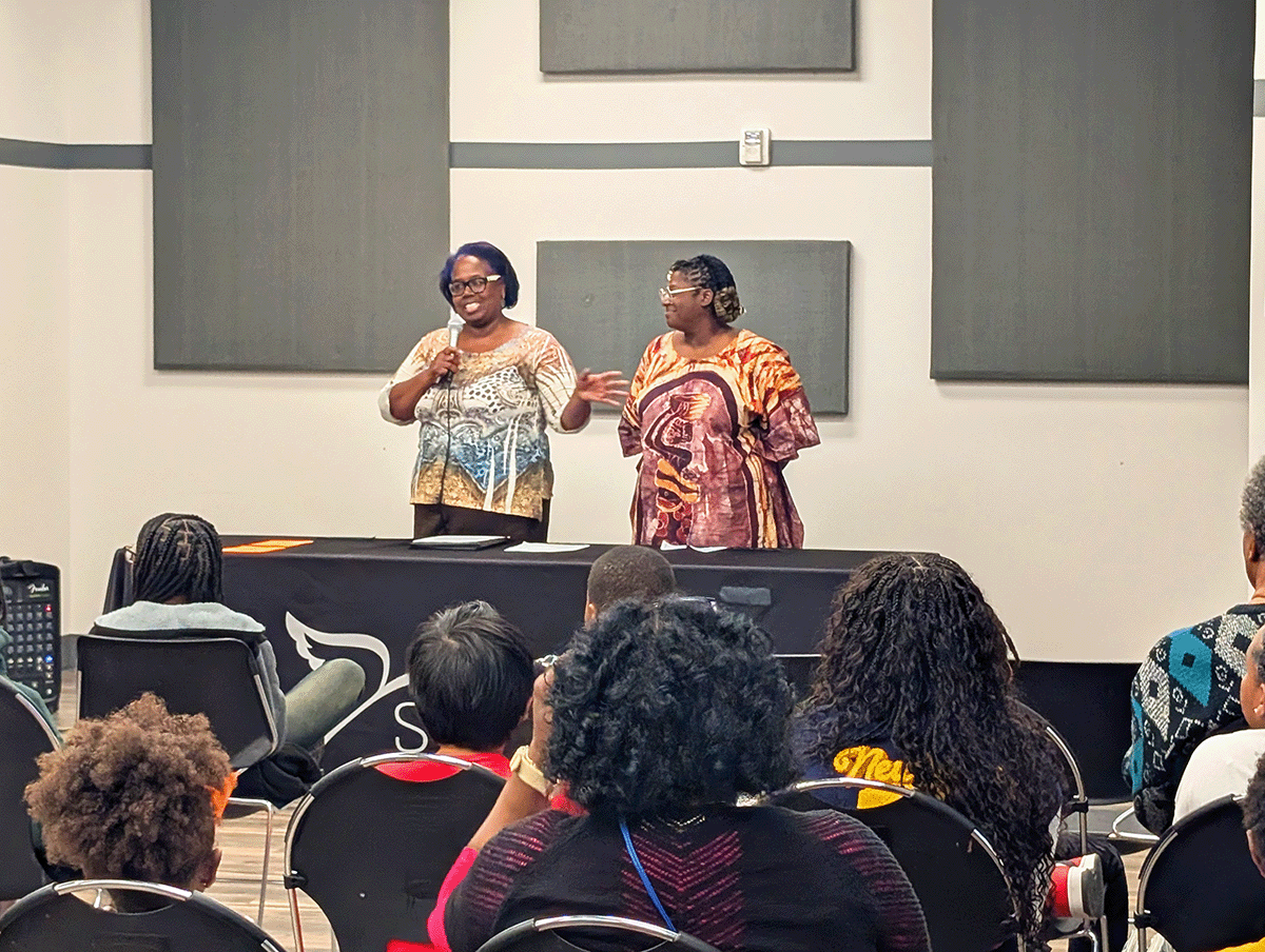 Vanderbilt Chief Community Impact Officer, Midori Lockett, and lead artist, Elisheba Israel Mrozik address Salama students and community members gathered to celebrate the mural unveiling.