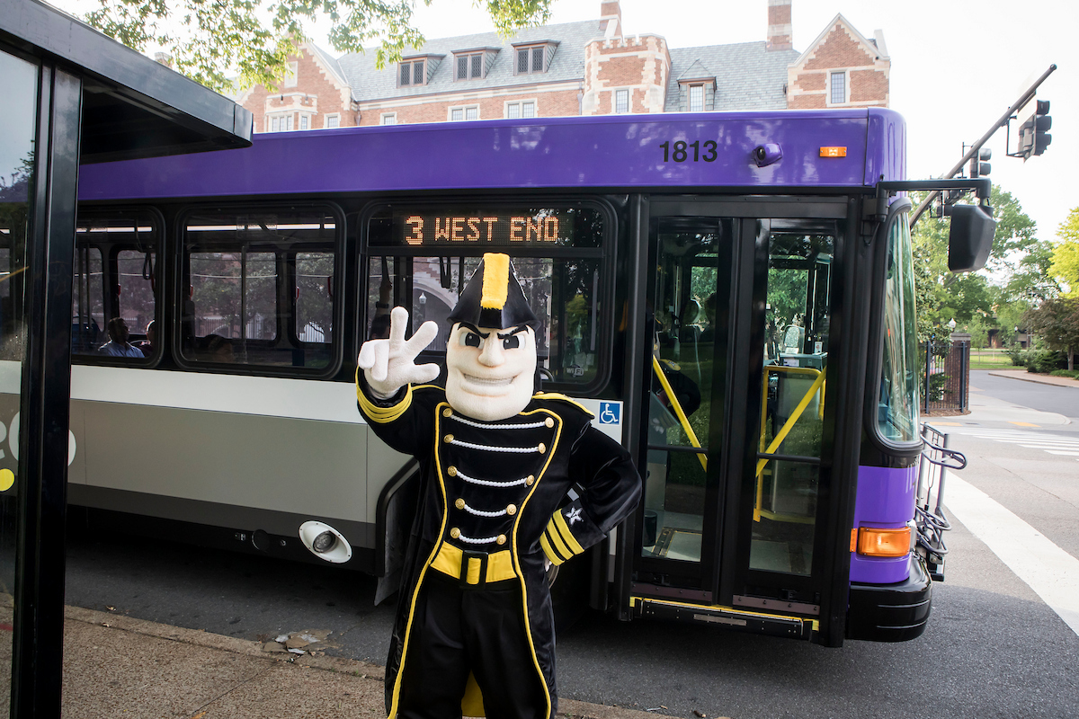 Mr. C poses with the WeGo bus on West End