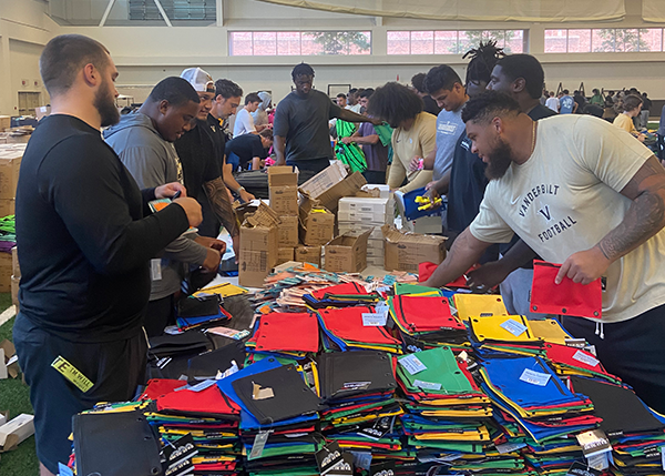 Vanderbilt student-athletes and staff volunteer with PENCIL on a backpack-stuffing project. 