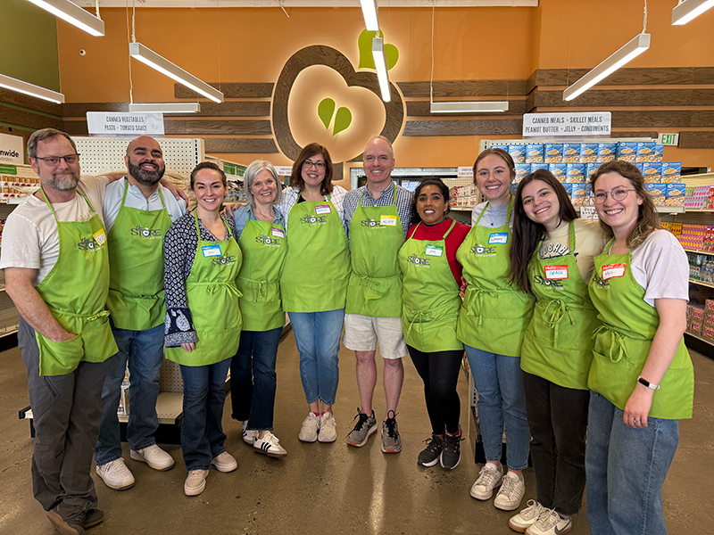 Vanderbilt faculty and staff pose for a group photo while volunteering at The Store