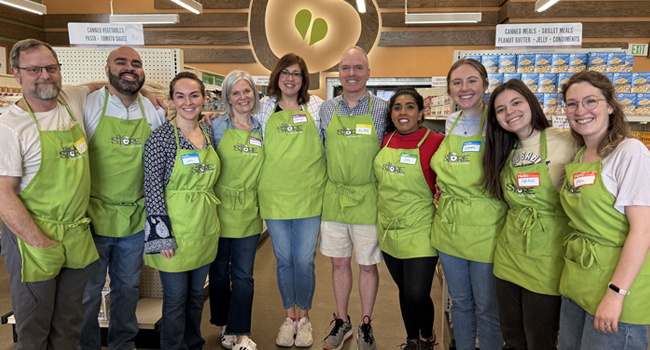 Vanderbilt faculty and staff members pose for a group photo while volunteering at The Store