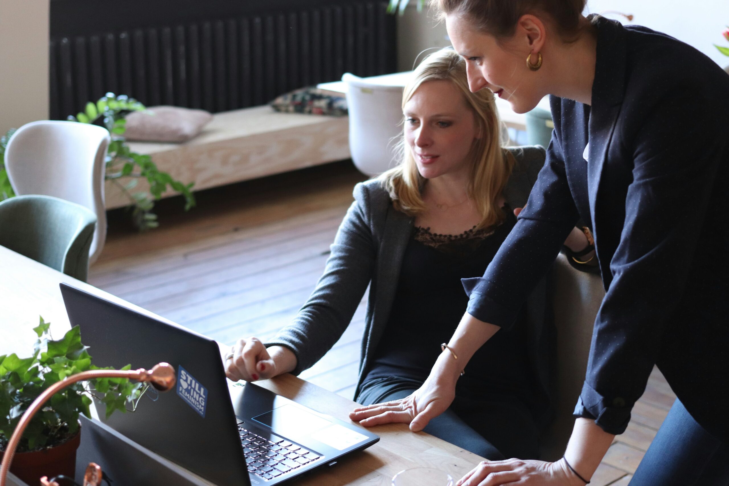 Two women looking at a computer