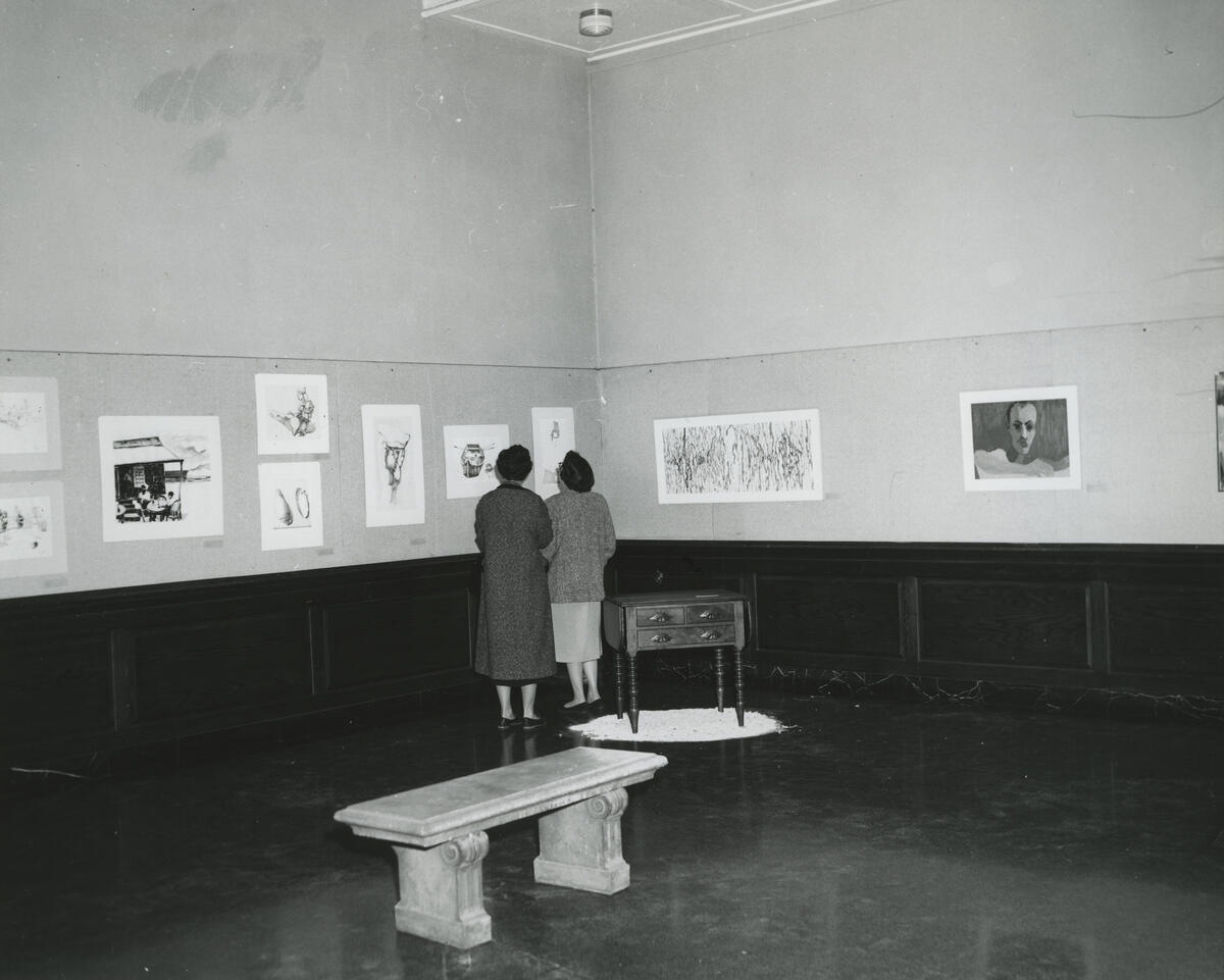 women looking at exhibition