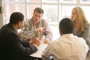 Master of Management in Healthcare students work in a team setting.